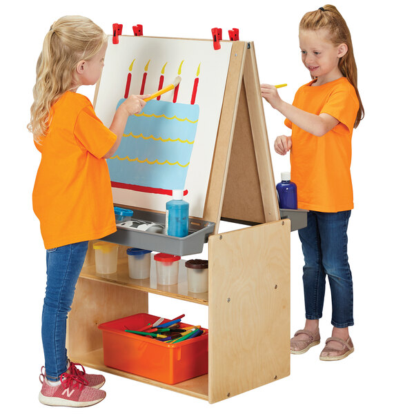 A girl painting at a Young Time natural wood 2-station art easel.