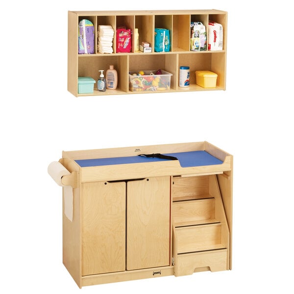 A Jonti-Craft wooden baby changing table with shelves and a blue cabinet.