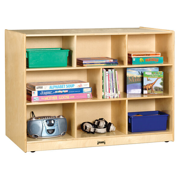 A Jonti-Craft wooden double-sided storage island with books on it.