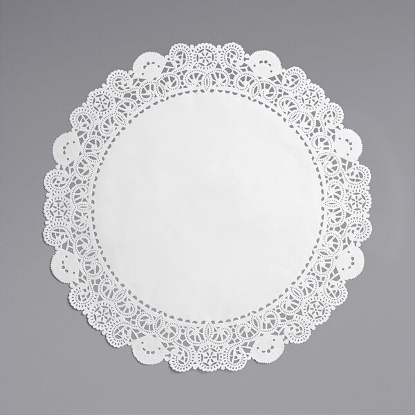 A white Hoffmaster lace doily on a gray surface.