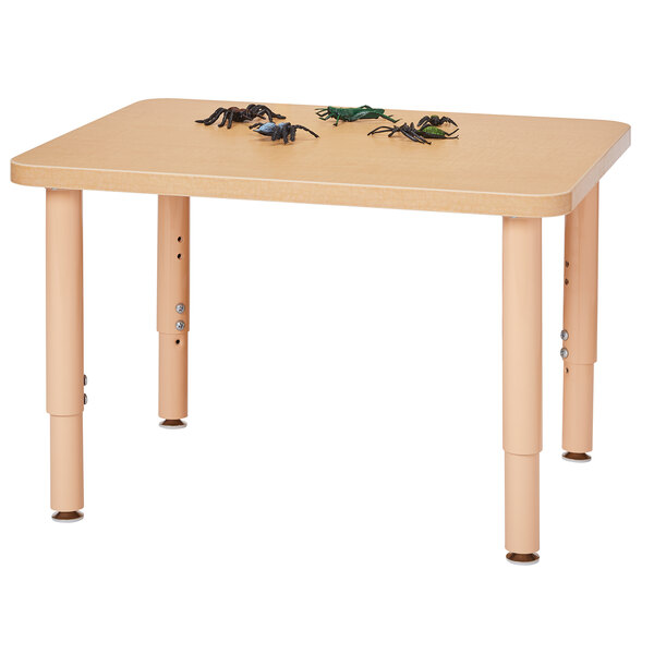 A Jonti-Craft Baltic Birch rectangle table with toys on it.