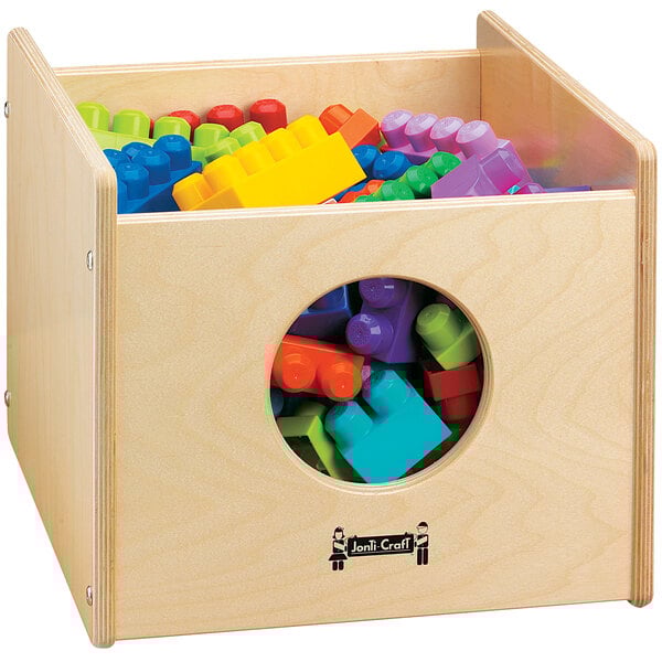 A Jonti-Craft wooden bin filled with colorful building blocks.
