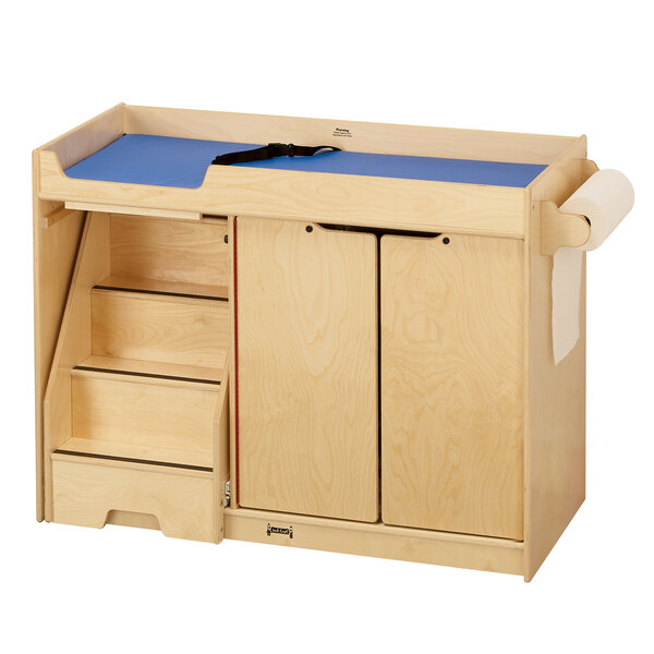 A Jonti-Craft wooden toddler changing cabinet with paper roll dispenser.