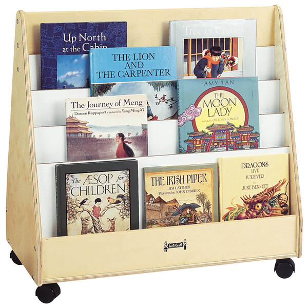 A Jonti-Craft wooden rack with wheels holding books.