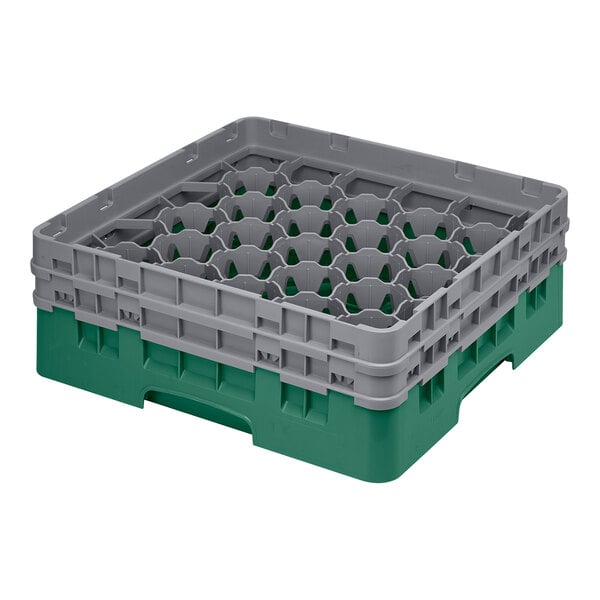 A green and grey plastic Cambro glass rack with compartments.