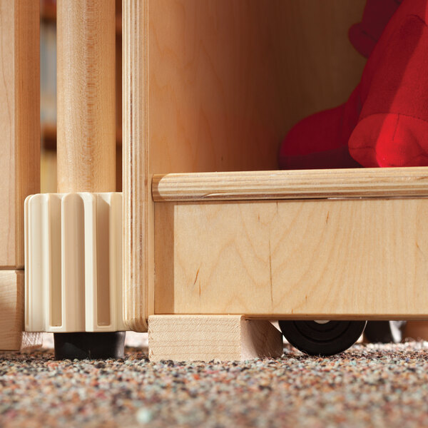 A wooden shelf with a red stuffed animal on a KYDZ Suite Immobilizer Block.