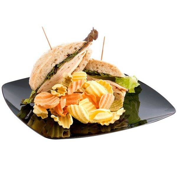 A Fineline black plastic plate with a turkey sandwich, chips, and pasta.