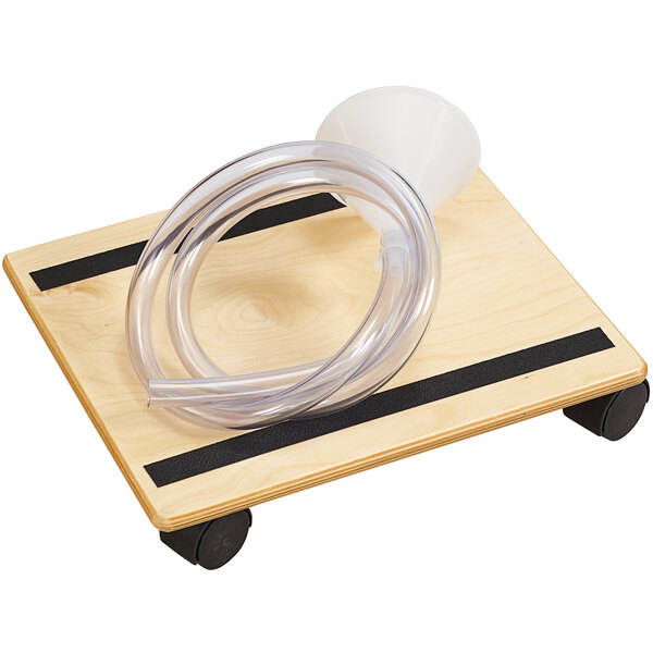 A Jonti-Craft Baltic Birch accessory kit with a plastic tube on a wooden surface.