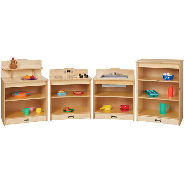 A Jonti-Craft toddler kitchen set with wooden shelves holding dishes and utensils.