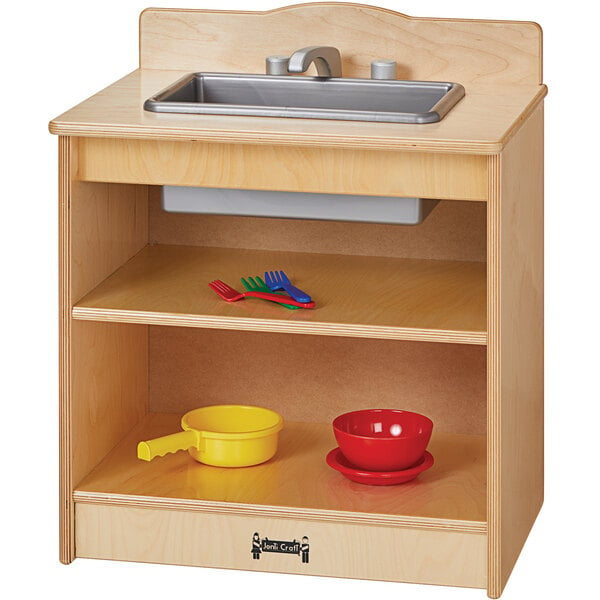 A Jonti-Craft wooden toddler kitchen sink with bowls on a counter.