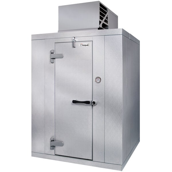 A Kolpak floorless indoor walk-in cooler with a door open.