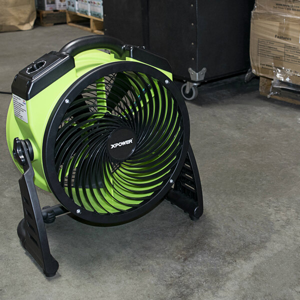 A green and black XPOWER FC-200 fan in a black box.
