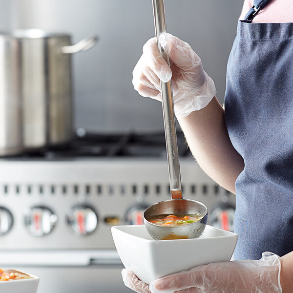 a person holding a bowl of soup