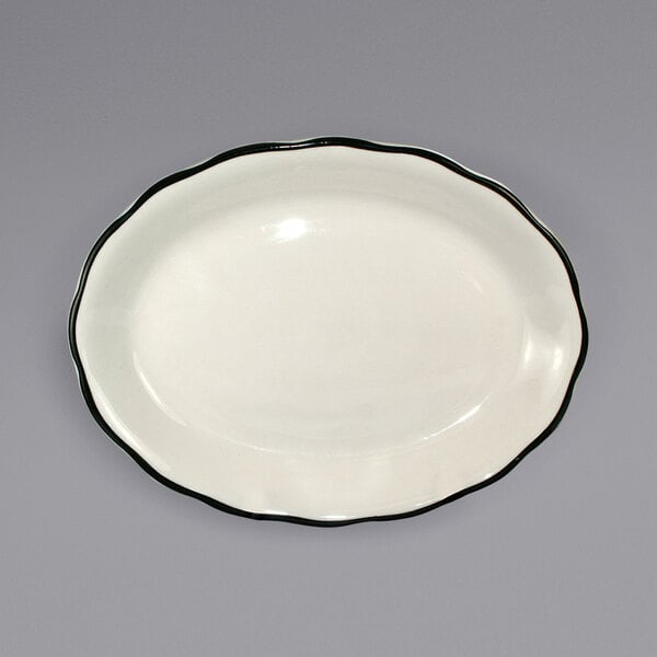 A white stoneware platter with a black rim.