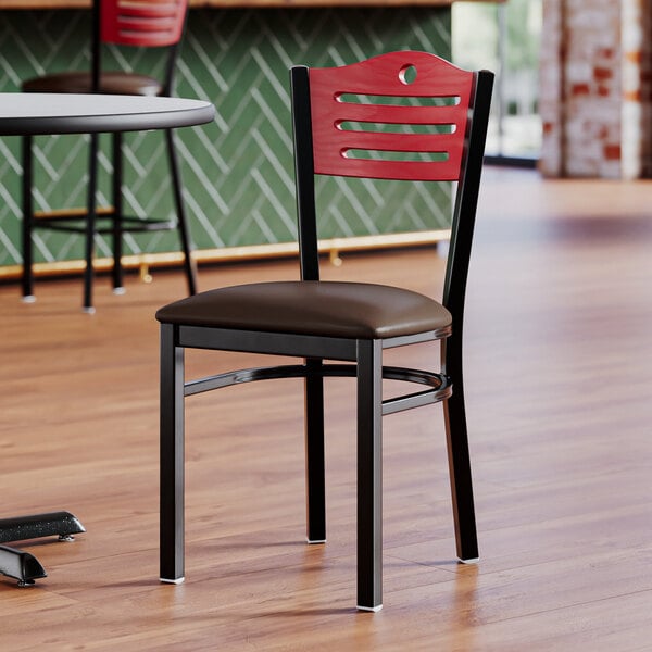 A Lancaster Table & Seating restaurant chair with a mahogany wood back and black frame.