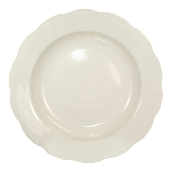 A round ivory stoneware pasta bowl with a scalloped edge.