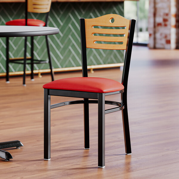 A Lancaster Table & Seating side chair with a red vinyl seat and natural wood back.