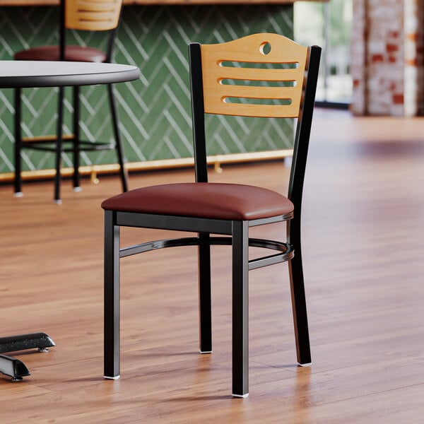 A Lancaster Table & Seating side chair for restaurants with a natural wood back and burgundy vinyl seat.