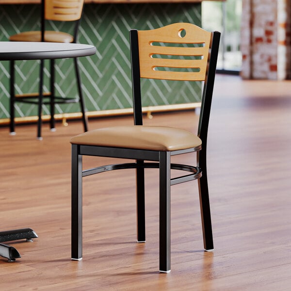 A Lancaster Table & Seating black wood side chair with a light brown vinyl seat and natural wood back.