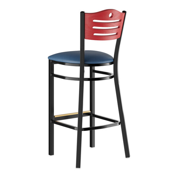 A Lancaster Table & Seating black bar stool with a navy cushioned seat and mahogany back.