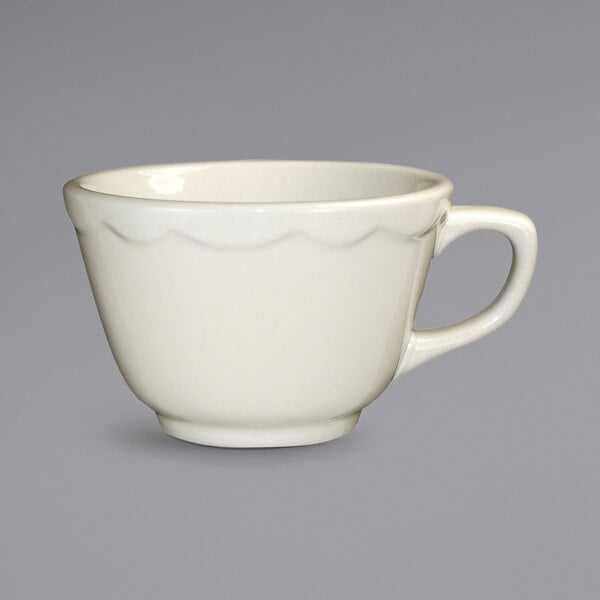 A white Victoria stoneware tall cup with a handle.
