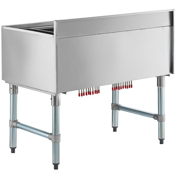 A stainless steel Regency underbar ice bin with red tubes attached.