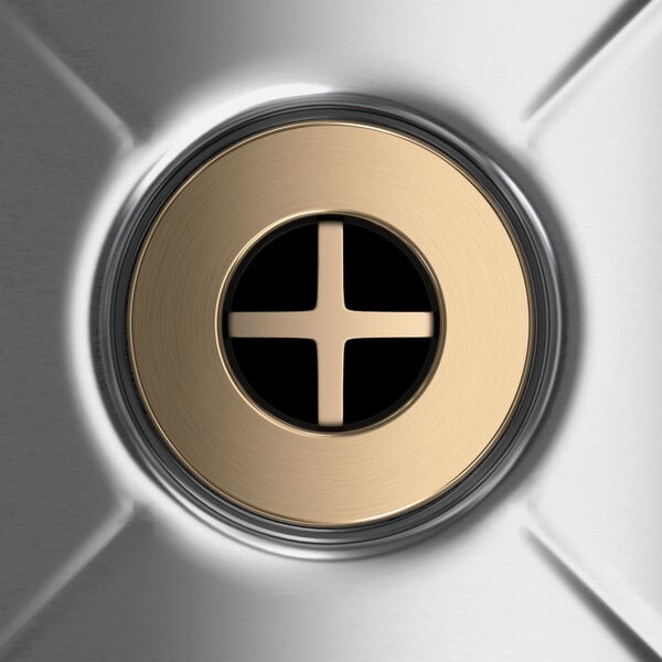 A circular metal button with a cross in it.