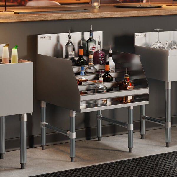 A five-tiered stainless steel liquor display rack holding various bottles, designed for bar use.
