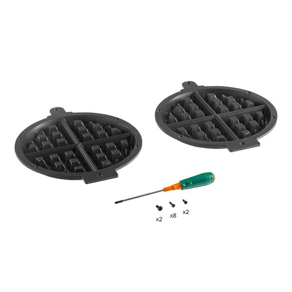 A pair of Waring WW180X waffle plates with a screwdriver.
