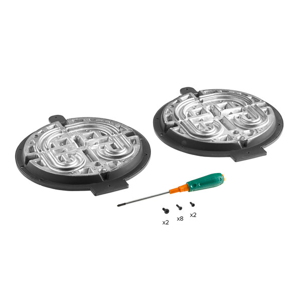 A close-up of two round plastic light covers with screws and a screwdriver.