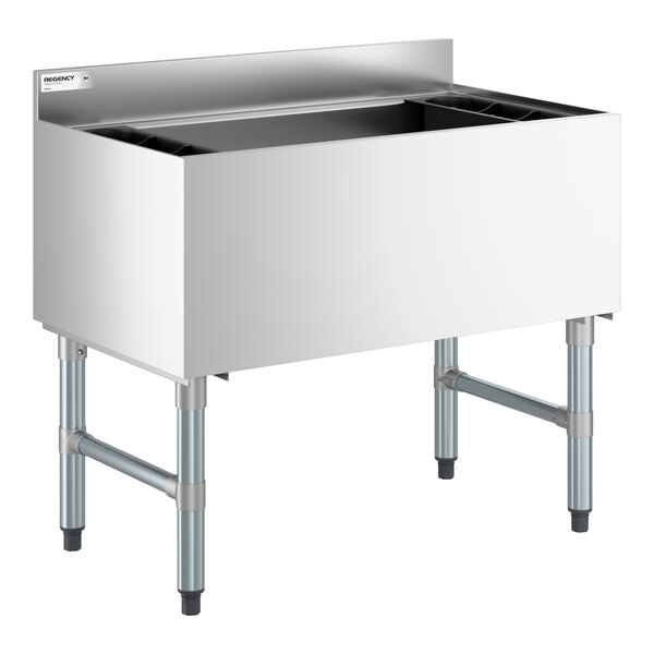 A stainless steel underbar ice bin with a backsplash, four sturdy legs, and bottle holders on each side.