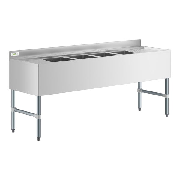 A Regency stainless steel underbar sink with two drainboards.