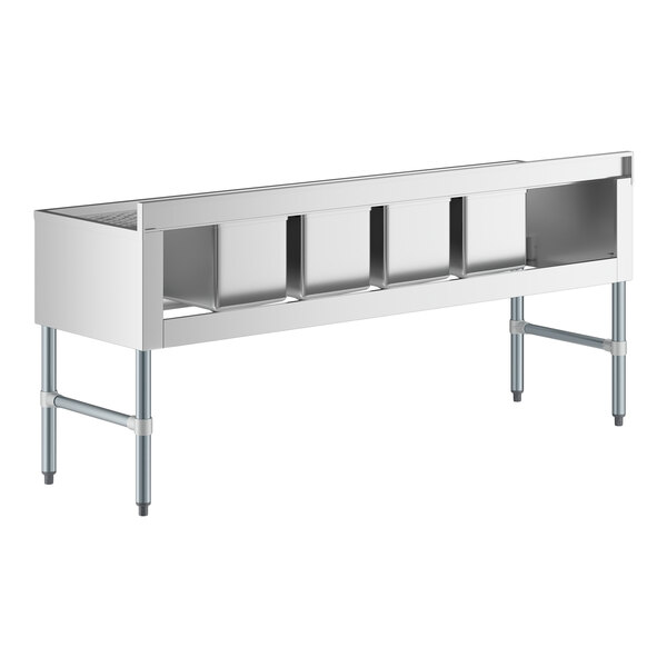 A Regency stainless steel underbar sink with two drainboards and four compartments on a counter.