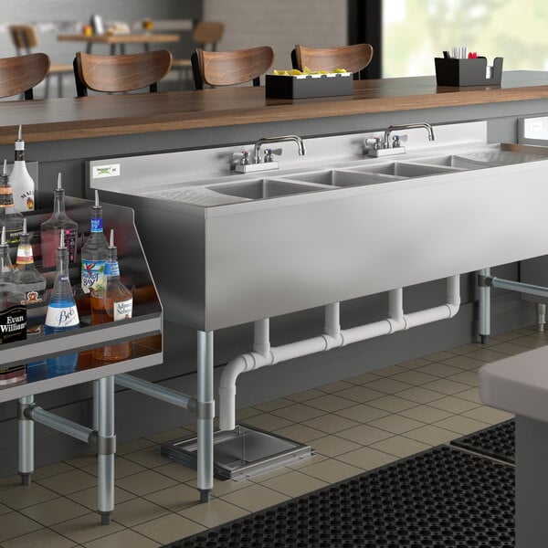 A Regency underbar sink with two drainboards on a counter.