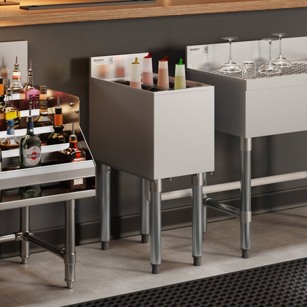 A stainless steel underbar ice bin with bottle holders designed for bar use.