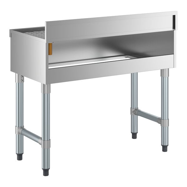 A stainless steel underbar drainboard with four legs and a raised backsplash, measuring 36 inches by 18 inches.