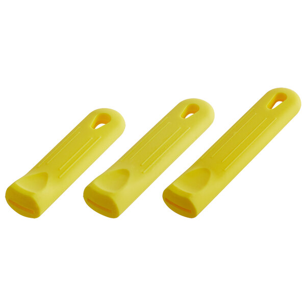 A group of yellow silicone pan handle sleeves.