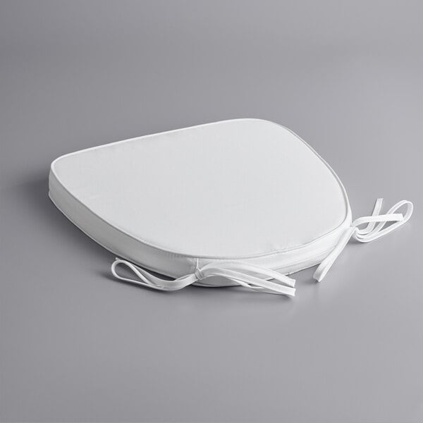 A white cushion with ties.