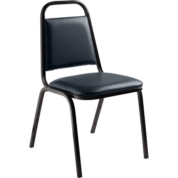 A black National Public Seating stackable chair with a black seat and back and midnight blue upholstery.