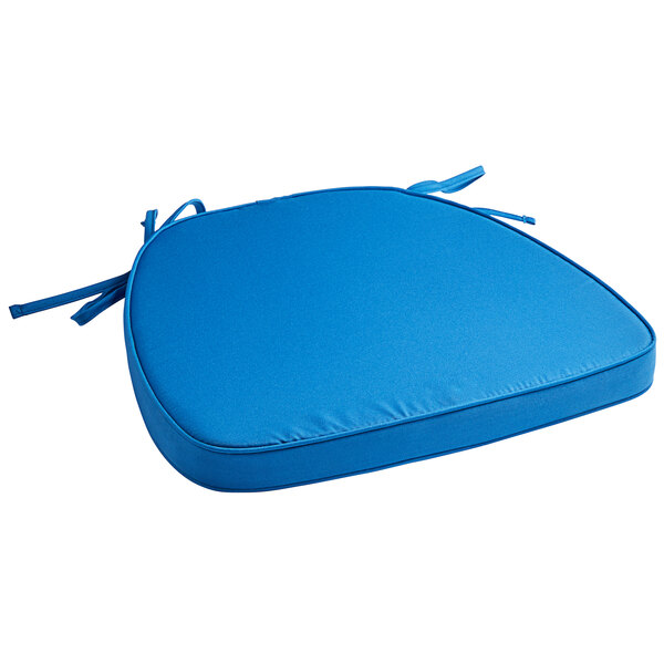 A blue Lancaster Table & Seating Chiavari chair cushion with ties.