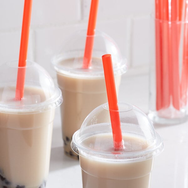 A close-up of a Choice red pointed wrapped straw in a plastic cup.