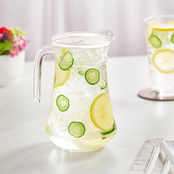 An Acopa glass pitcher of water with lemons and cucumbers.