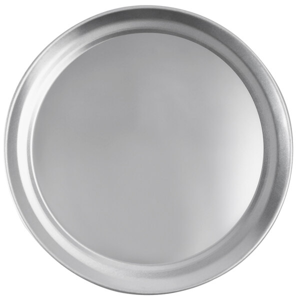 A close-up of a round silver Vollrath pizza pan.