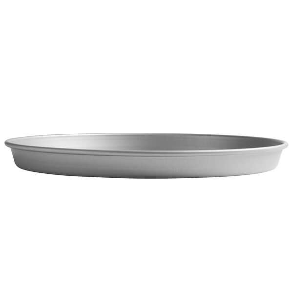 A close-up of a round silver Vollrath tapered deep dish pizza pan.