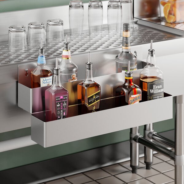 A 24-inch Steelton stainless steel double tier speed rail holding various liquor bottles.