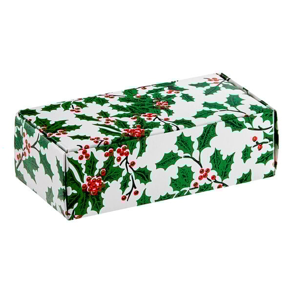 A white box with green and red holly leaves and berries.