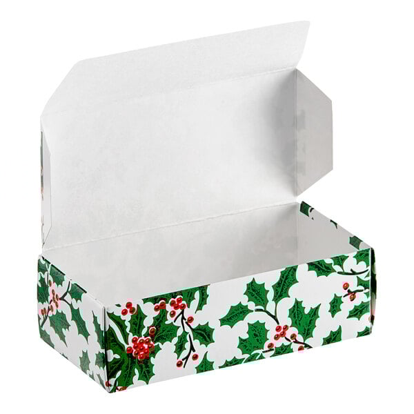 A white 1/2 lb. Holly Holiday candy box with an open lid decorated with holly and berries.