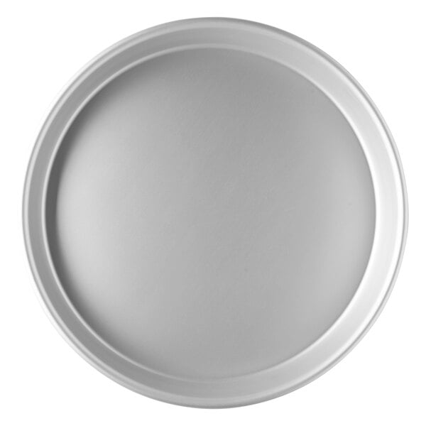 A close-up of a round white Vollrath pizza pan with a tapered edge.