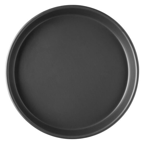 A black round Vollrath pizza pan with tapered sides.