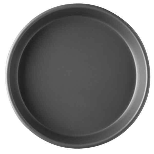 A close-up of a Vollrath hard coat anodized pizza pan.